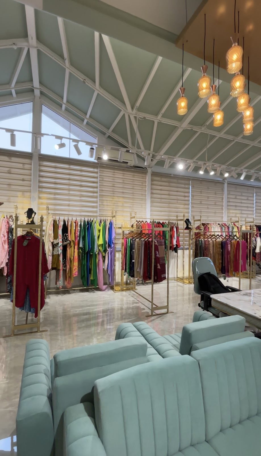 Pale green seating and apparel displays inside Kalii